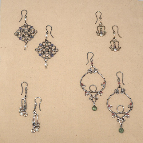 Four pairs of copper earrings with silvery patina