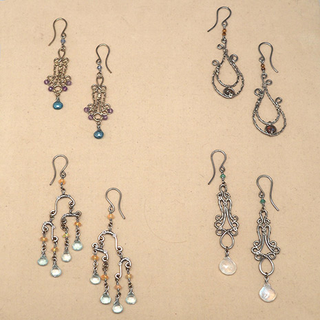 Four pairs of copper earrings with silvery patina